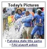 Winning football players dump water on their coach